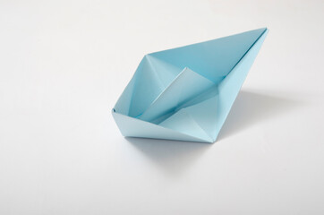 paper boat on blue