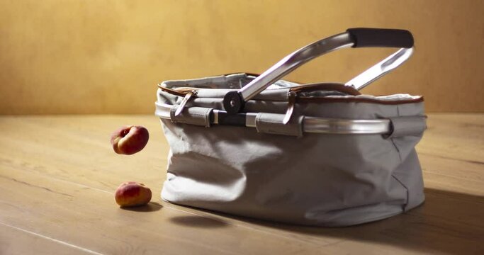 A picnic bag is filled with foods - sandwiches, fruit, a bottle of wine and two glasses. Stop motion animation