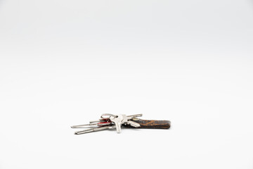 Bunch of keys with old and worn keychain isolated on white background.