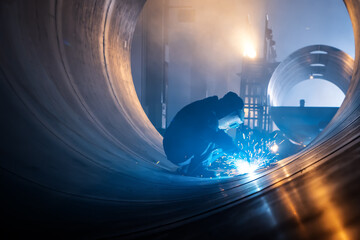 The welder is welding steel plates