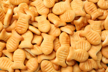 Delicious goldfish crackers as background, closeup view