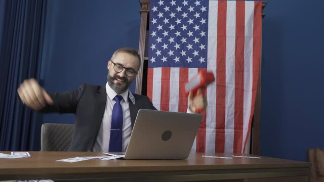 Rich business vintage, white gentleman, Caucasian person with american or usa flag using money gun in financial account and investment concept with computer notebook laptop.