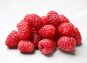 Delicious fresh ripe raspberries on white table, closeup