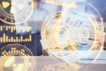 Technology theme hologram with man working on computer on background. High tech concept. Multi exposure.