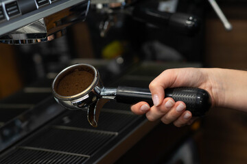 The process of making coffee on a coffee machine. Pressed coffee tablet in a holder, ready to be installed in a coffee machine.