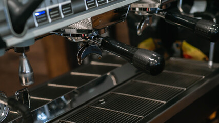 Fototapeta na wymiar The process of making coffee on a coffee maker. Holder installed in the coffee machine.
