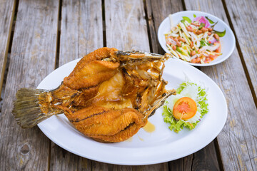 Deep Fried Snapper topped with sweet fish sauce and mango salsa.