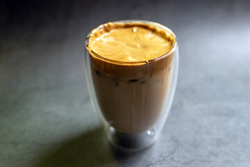 Dalgona Coffee; fluffy whipped coffee on milk. Coffee is a beverage made by whipping equal proportions of instant coffee, sugar and hot water until it becomes creamy and adding it to cold or hot. 