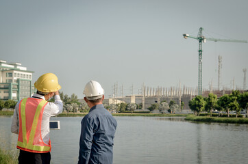 Engineers discuss site planning and analyze building construction.
