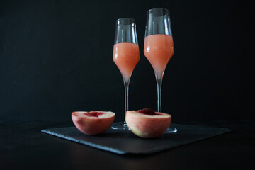 two glasses of Bellini, a cocktail made with peach juice and white wine