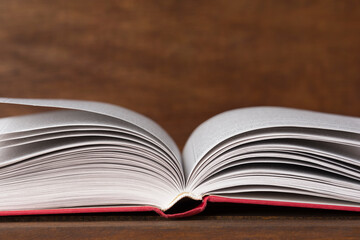 Close up of open book on old wooden background