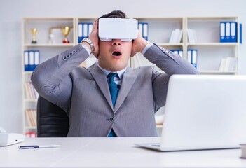 Businessman with virtual reality glasses in modern technology co