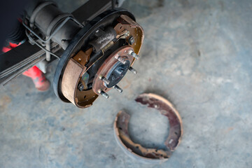 Drum brake and asbestos brake pads at car garage