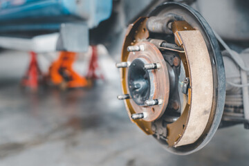 Drum brake and asbestos brake pads at car garage