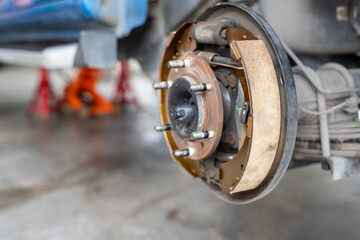 Drum brake and asbestos brake pads at car garage