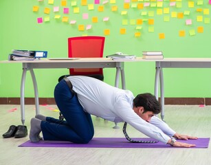 Man in the office with many conflicting priorities doing exercis