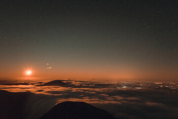 Moonrise, comet and stars landscape above the mountain in autumn season