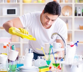 Man enjoying dish washing chores at home