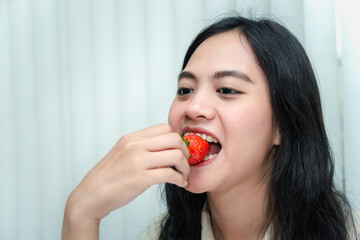 Woman eat strawberry red berry fruit sweet juicy