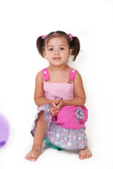 Little girl is playing with a balloon