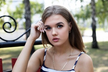 Closeup portrait of a young attractive girl against blurred background. Shallow focus.