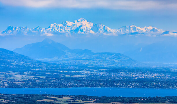 Image of snow-capped Mont Blanc Massif and Leman Lake seen from Jura Mountains in France.
