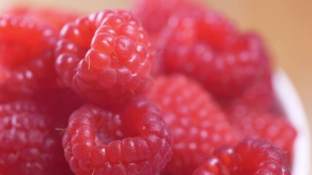 Close up footage of fresh fruits in the kitchen. Beautiful raspberries close up footage.