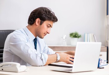 Young handsome businessman working in office