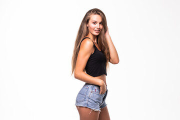 Portrait of sensual woman in shorts and crop top over white background