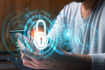 Man using phone. Hands typing smartphone. Double exposure with lock icon hologram. Close up. Datum cyber safety concept. Protection from hacker attack.