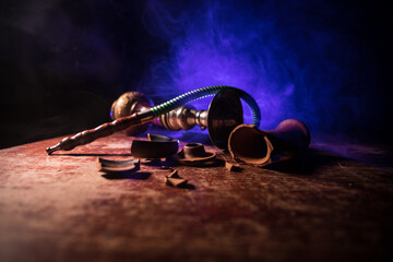 Hookah hot coals on shisha bowl making clouds of steam at Arabian interior. Shisha concept. Broken...