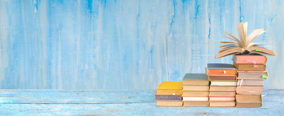 Stack of books and an open book. Reading,literature,education,library,home office concept,...