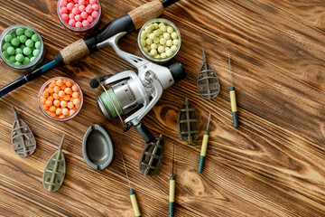 Accessories for carp fishing and fishing baits on wooden planks with copy space