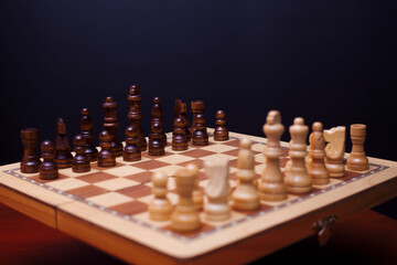 A game of chess, the beginning of a chess game two sides opposite each other.