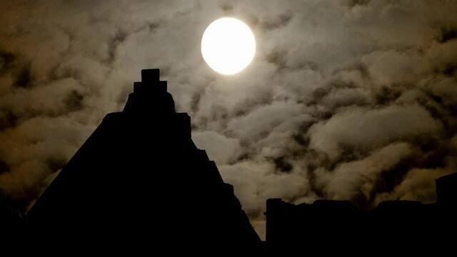 Dark Atmosphere in Uxmal, Time Lapse by Night with Full Moon and Pyramid of the Magician in Silhouette, Mexico