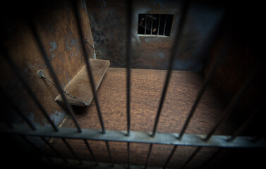 Jail or prison cell. Old grunge prison miniature. Dark prison interior creative decoration. Empty...