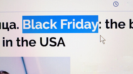 Black Friday is covered in headlines and news sites around the world. Close up view of computer monitor screen. Sales season. Stop movement.