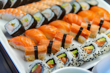 Assorted sushi and rolls displayed on a white plate