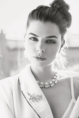 Black and white portrait of woman in necklace with pearls