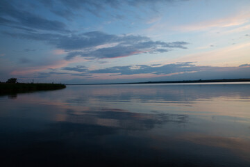 colored sunset over the river, with sky reflection