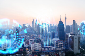 Hologram of abstract technology glowing icons, panoramic cityscape of Kuala Lumpur at sunset, Malaysia, Asia. The concept of worlds technological changes. Double exposure.