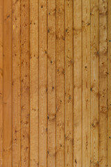 wall of brown wooden planks arranged vertical