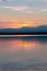 Obraz premium colored sunset over the river, with sky reflection