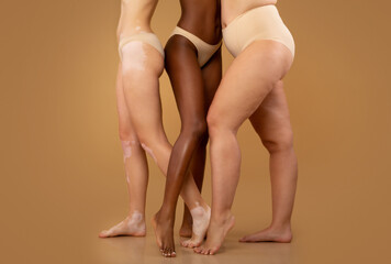 Tree women with different race and body sizes posing in underwear, cropped