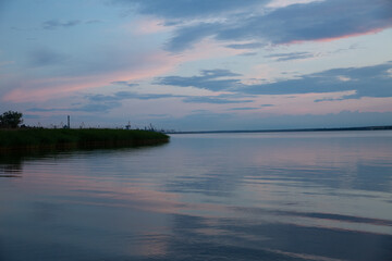 colored sunset over the river, with sky reflection