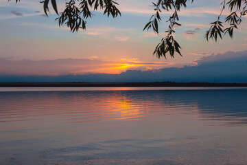 colored sunset over the river, with sky reflection