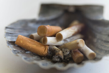 addictive cigarette butts extinguished in the ashtray