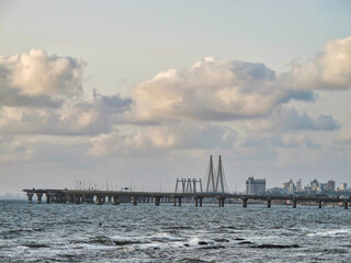 Fototapeta premium Mumbai skyline near Ocean with dramatic blue sky and clouds, India 