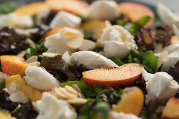 Closeup salad with nectarines, mozzarella and mixed greens