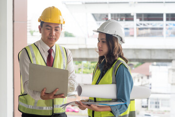 Engineer team discuss and planning from work site about construction building project with blueprint drawing paper. Copy space on right side.